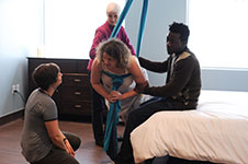 Midwife and couple in the birth centre with sling.