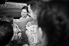 Photo of family around birth pool with newborn