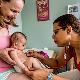 Midwife checking baby's heartbeat