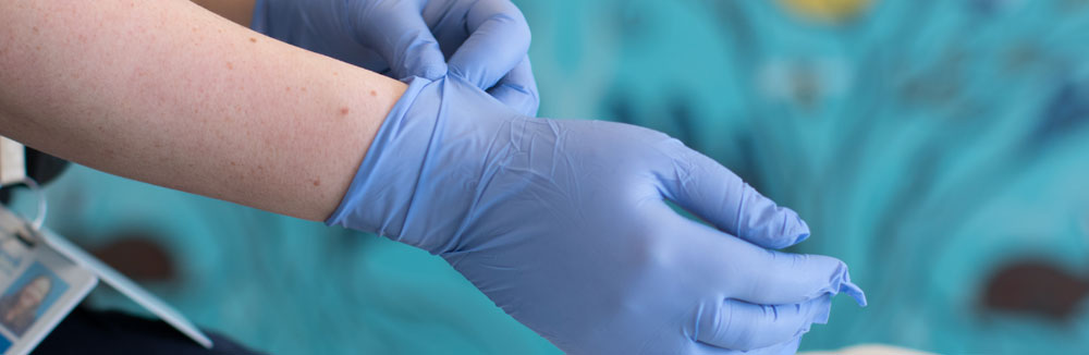 midwife applying sterile gloves